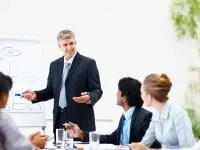 Mature business man training his associates during a meeting